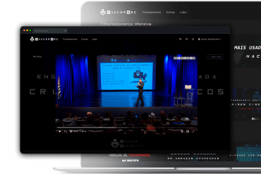 Pessoa trabalhando em um computador com códigos de cibersegurança na tela, símbolo de hacker e cadeado.