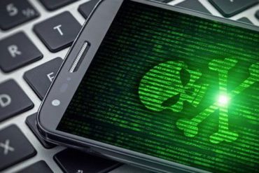 Homem experiente em hacking ético manipulando código em um laptop com tela do Android em destaque